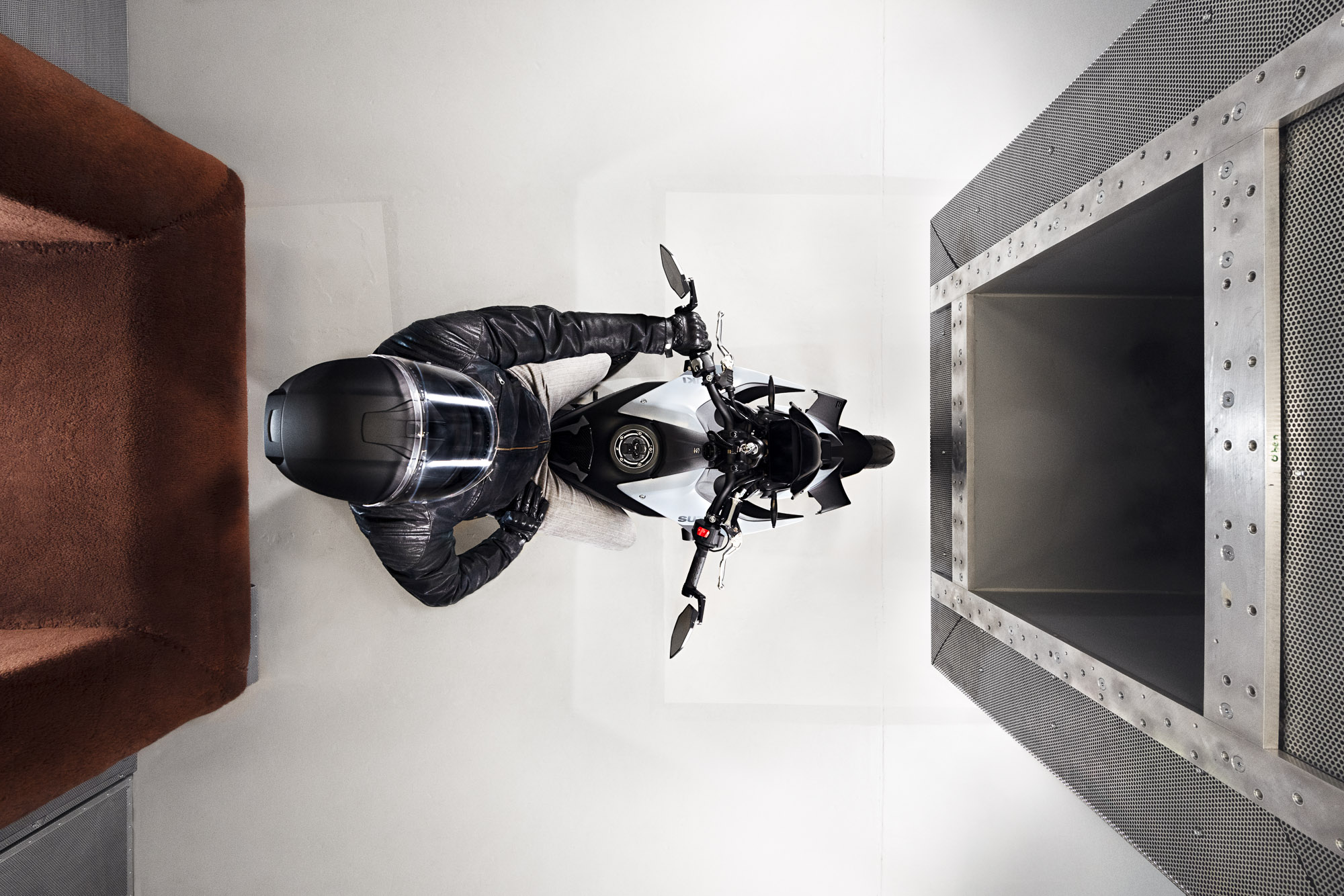 Image of a motorcycle rider in an aero acoustic wind tunnel by photographer Jan Söhlke