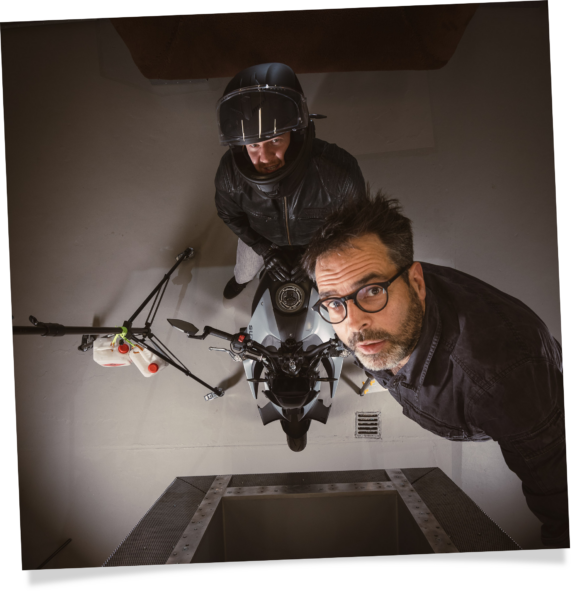 Self portrait of Dr Jan Söhlke, photographer for science, research, industry and corporate clients at work setting up an overhead shot during an assignment within the aero-acoustic wind tunnel at University of Siegen.
